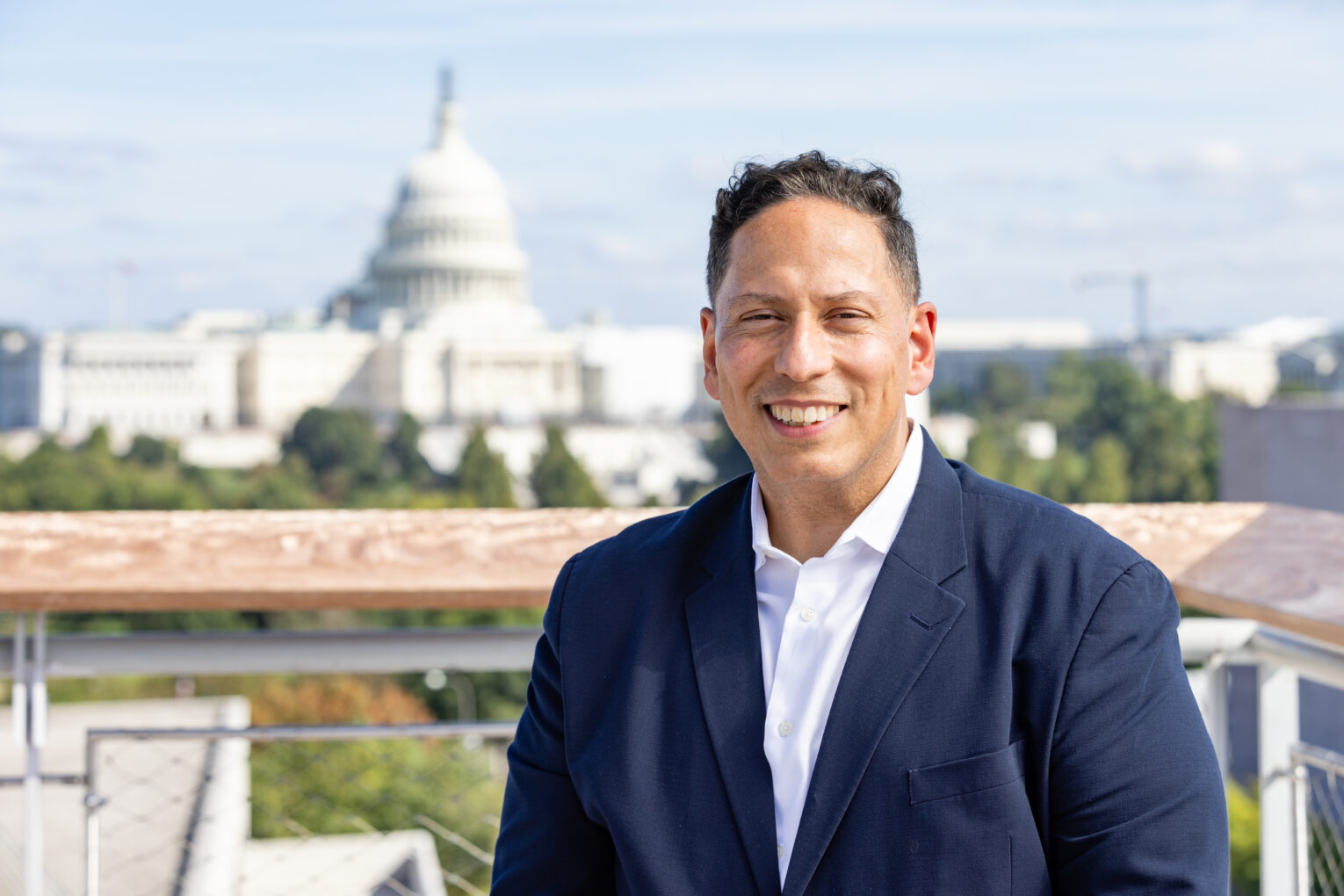 Vincent Guilamo-Ramos sitting with U.S. Capitol in background