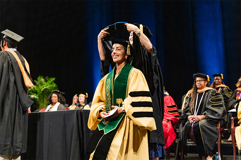 Dr Abeer Alharthi being robed during the SON 2024 August Graduation.