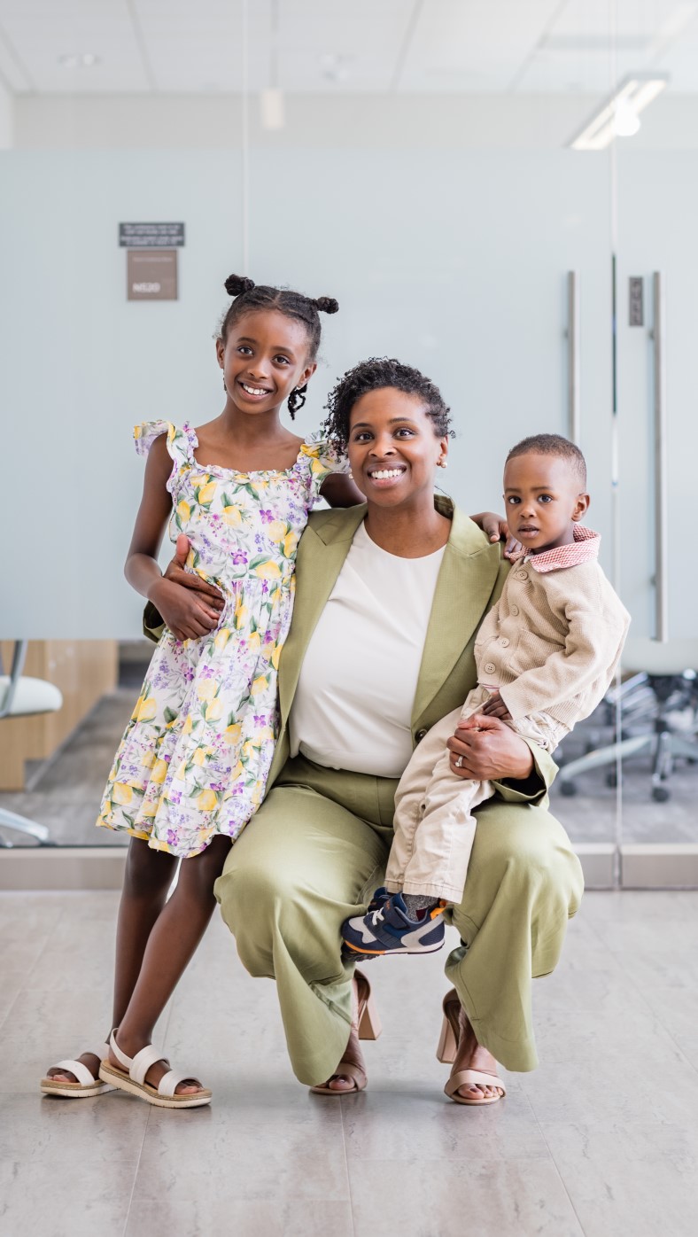 PhD candidate Aisha Ellis celebrates with family after a successful dissertation defense.