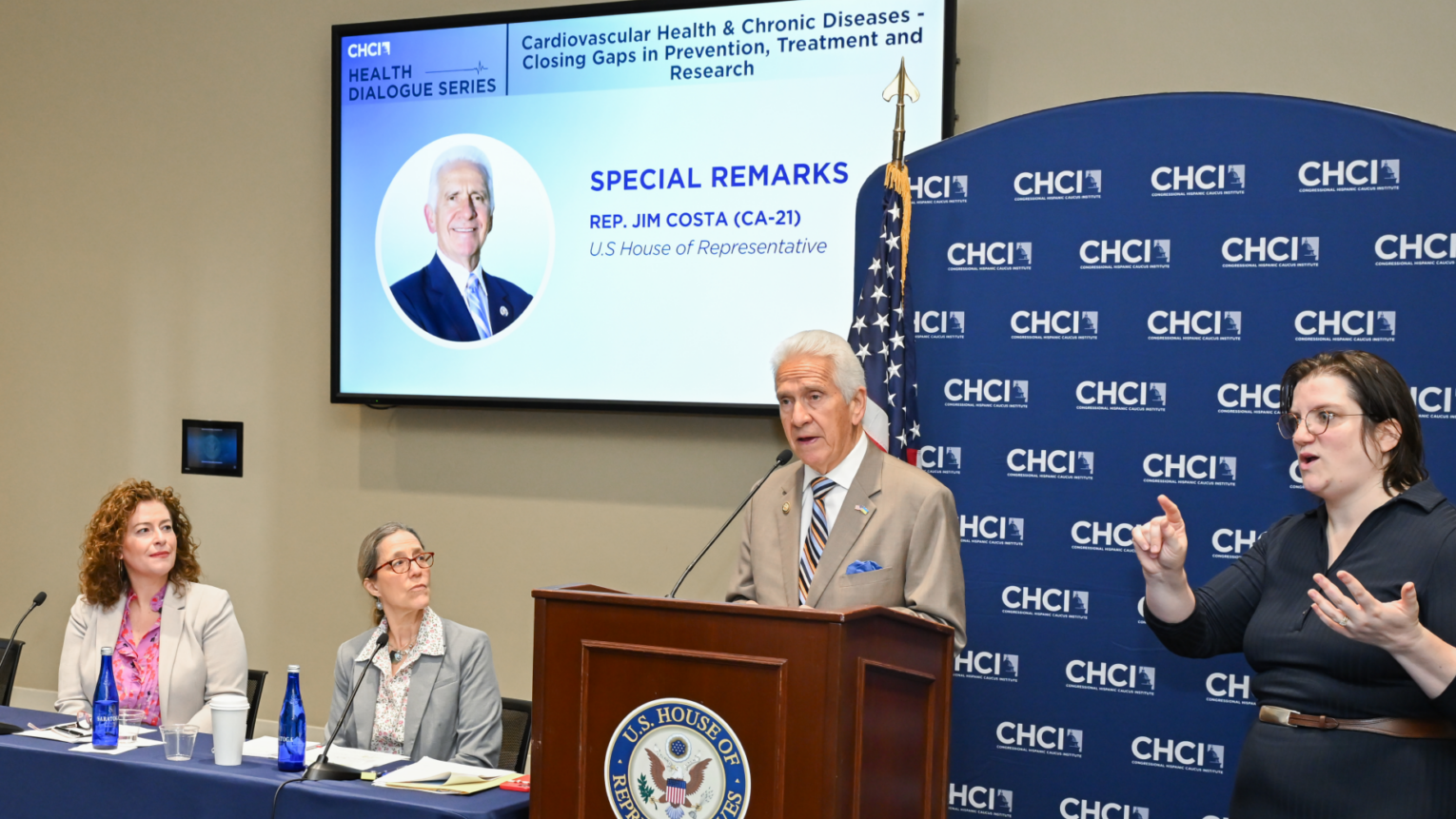 Associate Professor Melissa Hladek hears a presentation by U.S. Rep. Jim Costa of California